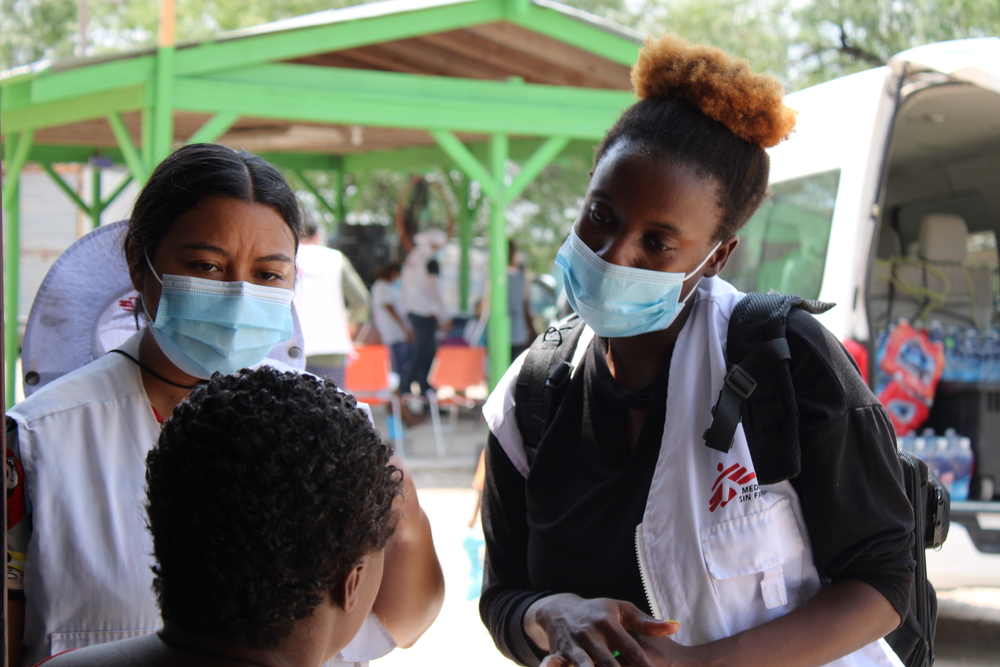 Zwei Mitarbeiterinnen unseres Teams der Gesundheitsberatung sprechen mit einer Frau in einer Unterkunft